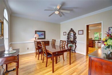 Dining room with crown and chair moulding, and bea