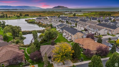 Aerial view of property's location with a water and mountain view and nearby suburban area