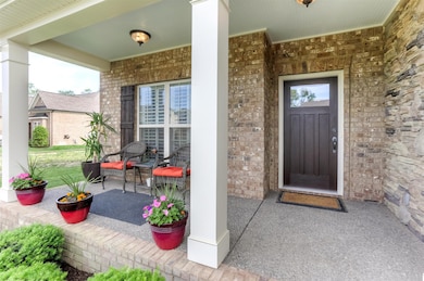Quaint front Porch. Stone wall adds a nice finishing touch