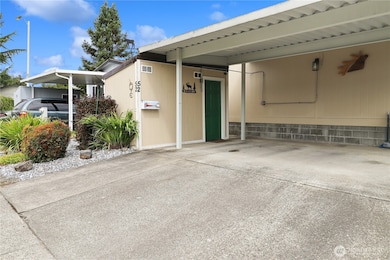 Double car carport provides covered parking, complemented by a storage shed with plenty of room for tools, lawn care, and extra storage.