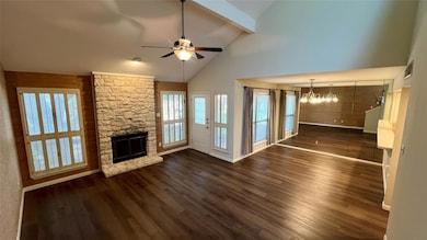 Unfurnished living room featuring a chandelier, c