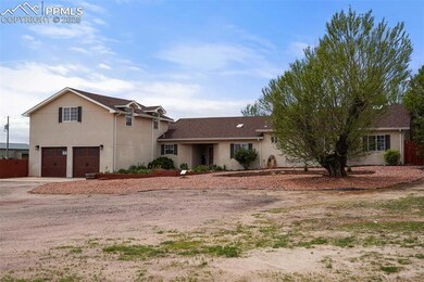 View of front of property with a garage, concrete driveway, and stucco siding