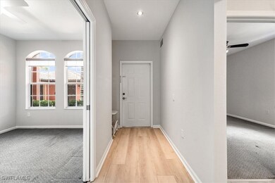 Hallway featuring wood finished floors and recesse
