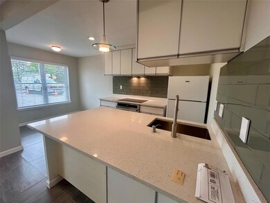 Kitchen featuring freestanding refrigerator, whit