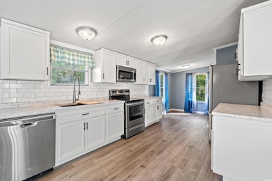 Kitchen with backsplash, a sink, ornamental moldin