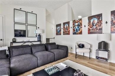 Living room with wood finished floors and lofted ceiling