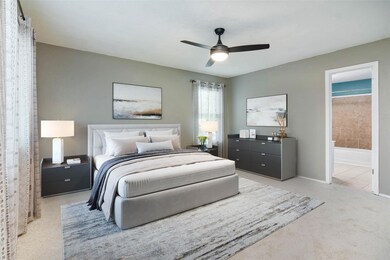 Carpeted bedroom with baseboards, ensuite bath, a