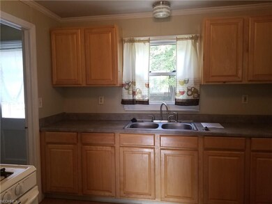 Kitchen offers backyard view, and leads to the fir