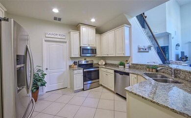 Light and bright kitchen featuring stainless appliances, 42'' custom solid wood cabinetry, nice sized closet pantry, entry to the garage and laundry room.
