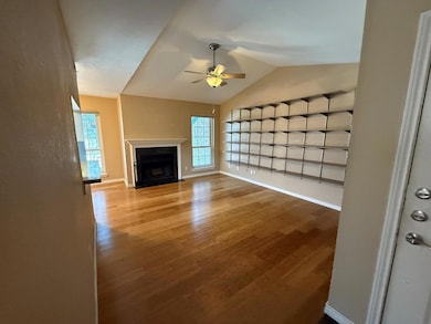 Unfurnished living room featuring ceiling fan, lof