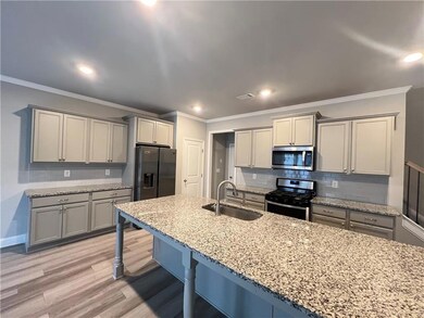 Kitchen with a breakfast bar area, crown molding, 