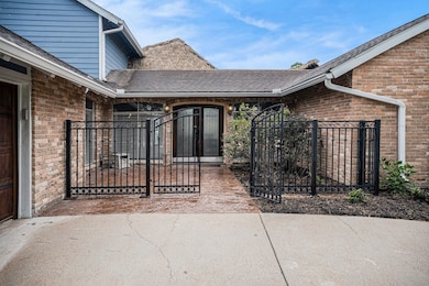 Welcoming front entry features a gated courtyard a
