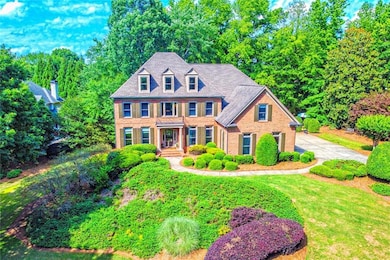 View of front of house with brick siding and drive