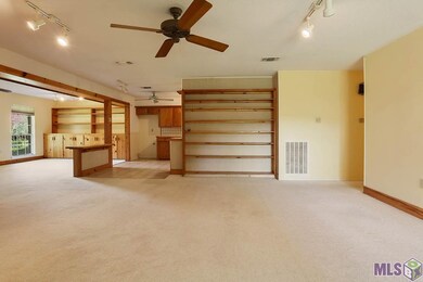The large den has built in shelving and is open to