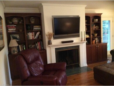 Cozy Family Rooms has custom built bookcases flank