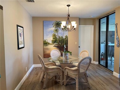 Designer light fixture in dining room with sliding
