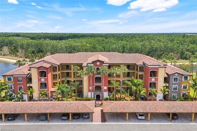 View of property with covered parking and a wooded