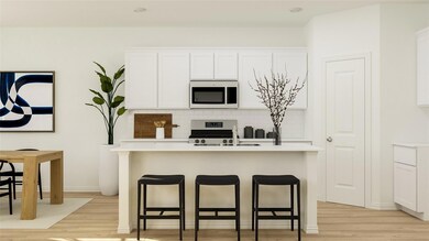 Kitchen with white cabinetry, a kitchen bar, decor