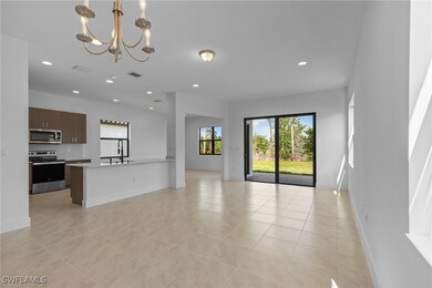 Unfurnished living room with a chandelier, light t