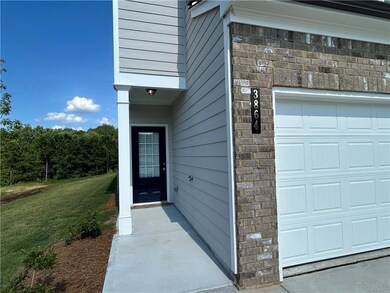 View of exterior entry featuring a yard and an attached garage