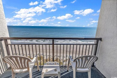 Balcony featuring a water view and a beach view