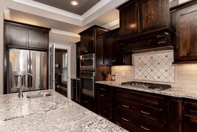 Granite countertops.  Island w/prep sink.  Gas cookstove.  Wine bar and wine fridge next to oven.