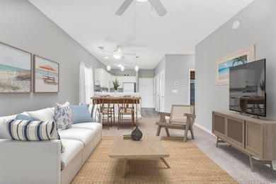 Carpeted living room with baseboards (Virtually Staged)