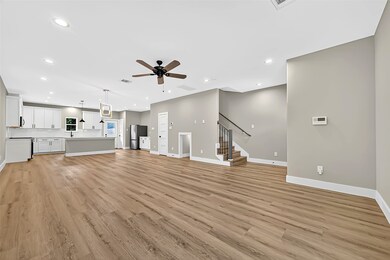 Step into an airy, light-filled living room with high ceilings and wide plank floors — perfect for entertaining or relaxing at the end of the day.