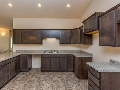 Kitchen with crown molding and raised cabinet over