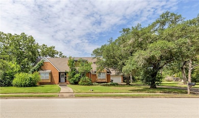 View of front facade with a front lawn and an atta
