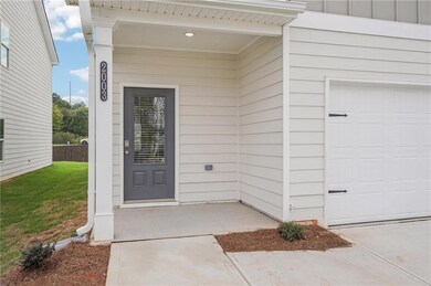 Doorway to property with a garage, board and batte