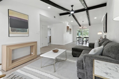 Living room with a chandelier, ceiling fan, reces