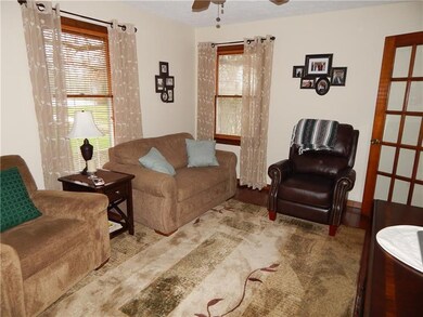 First floor den or tv room has hardwood floors and