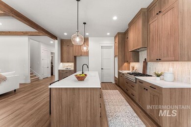 Kitchen featuring stainless steel gas stovetop, light wood-style flooring, recessed lighting, decorative backsplash, and brown cabinetry