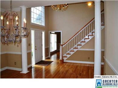 Stunning two-story foyer with custom moldings and 