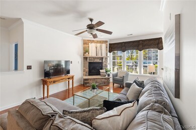 Living room features hardwoods, corner stone firep