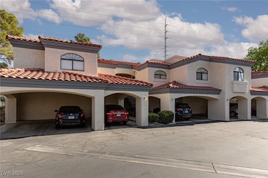 View of front of house with stucco siding and covered parking