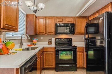 Kitchen featuring hanging light fixture, sink, mod