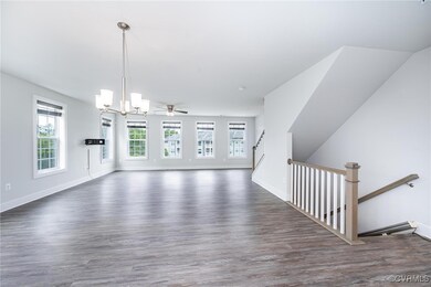 living room with a chandelier and wood finished fl