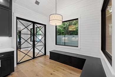 Unfurnished dining area with wood walls, visible 