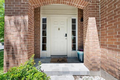 Doorway to property featuring brick siding