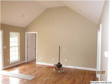 Living room. View shows hardwood floors and vaulte
