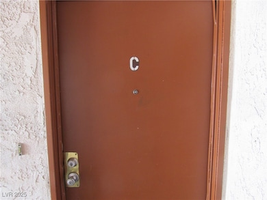 Entrance to property with stucco siding