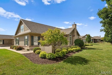View of side of home featuring stone siding, a yard, and roof with shingles