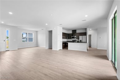 Unfurnished living room with recessed lighting and light wood finished floors