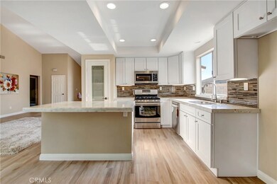 Brand new high-end kitchen, island counter is onyx with an LED circuit board light underneath, quartz counters, glass back splash, stainless appliances, brand new soft close cabinetry, new fixtures....