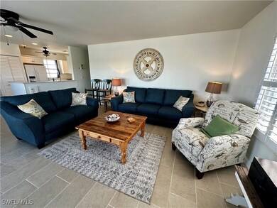 Living area with light tile patterned floors and a ceiling fan