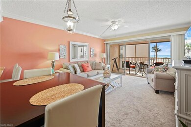 Carpeted living room featuring crown molding, ceil