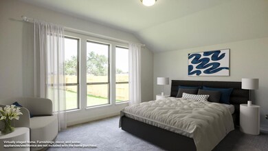 Carpeted bedroom with vaulted ceiling and baseboa