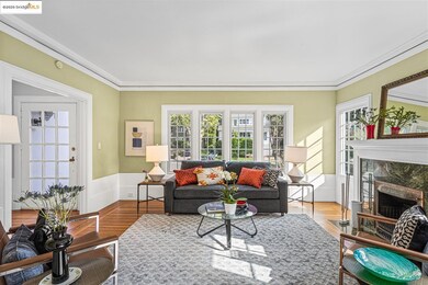 Living room with wainscoting, crown molding, and a premium fireplace